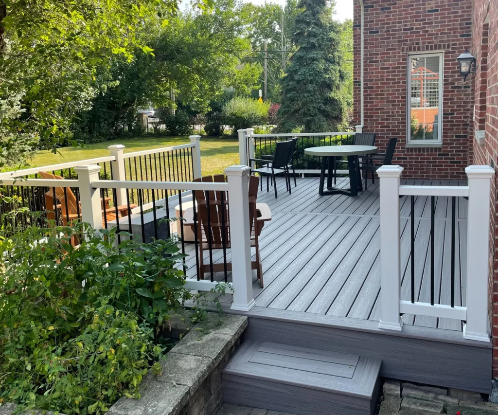 A newly installed Trex deck in a lush green backyard