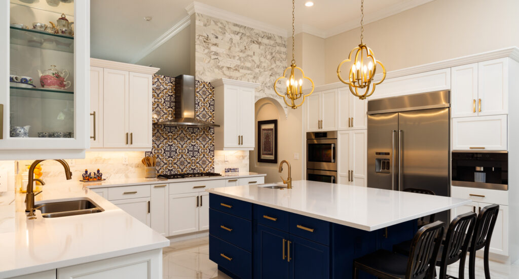 A large, expansive, modern kitchen with blue and gold accents. 