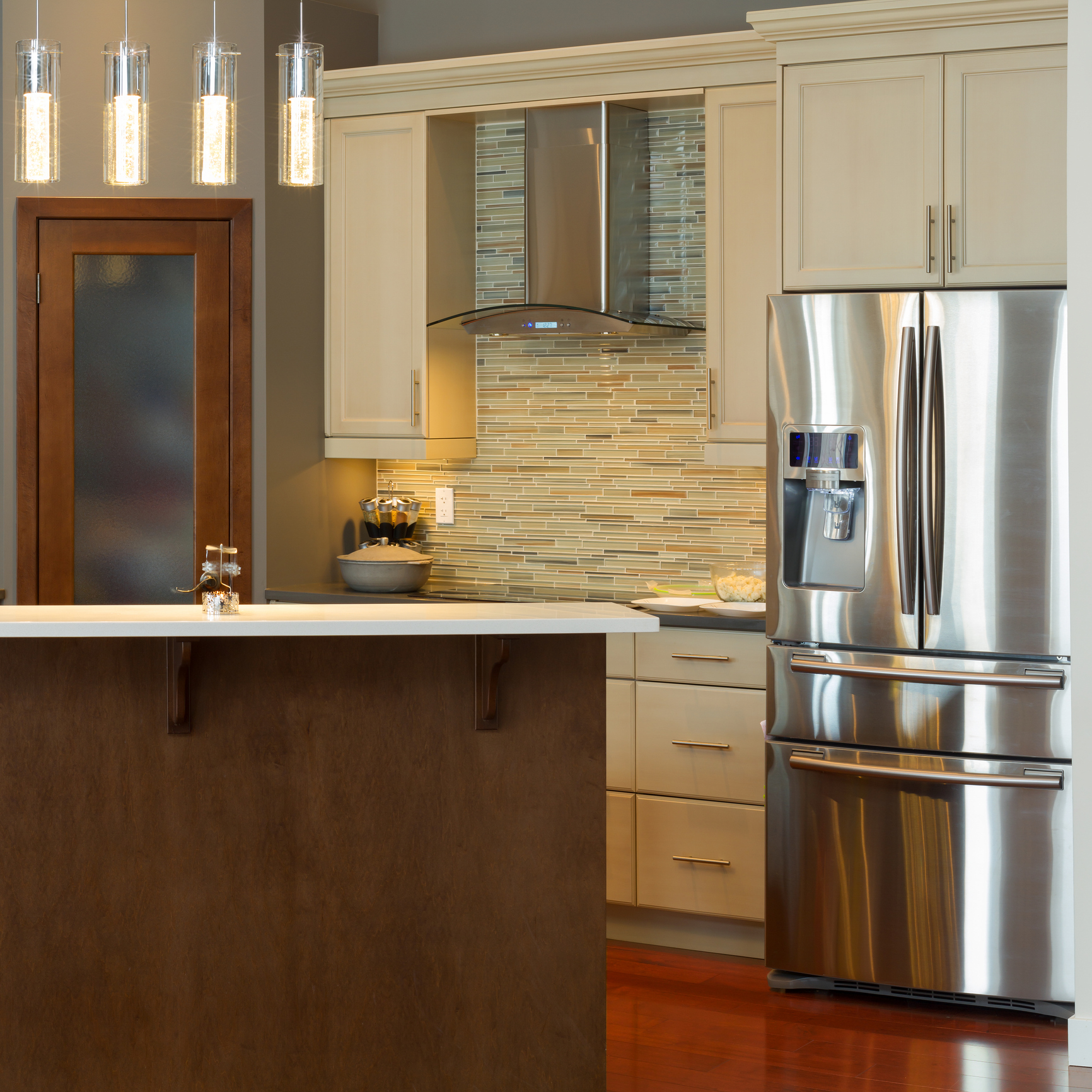 An image showing a newly remodeled kitchen with custom cabinets and countertops.